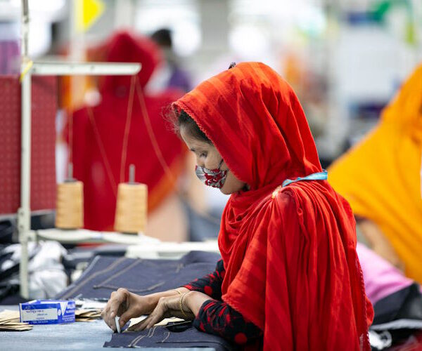 DHAKA, BANGLADESH - JULY 5: A garment worker works at a factory during a countrywide lockdown to try to contain the spread of Covid-19 on July 5, 2021 in Dhaka, Bangladesh. Bangladesh enacted a seven day lockdown on July 1st in an effort to contain a third wave of Covid, as cases have surged, fueled by the  Delta variant first detected in neighboring India. Under special arrangements with the government, garment factories across the country are allowed to stay open. (Photo by Allison Joyce/Getty Images)